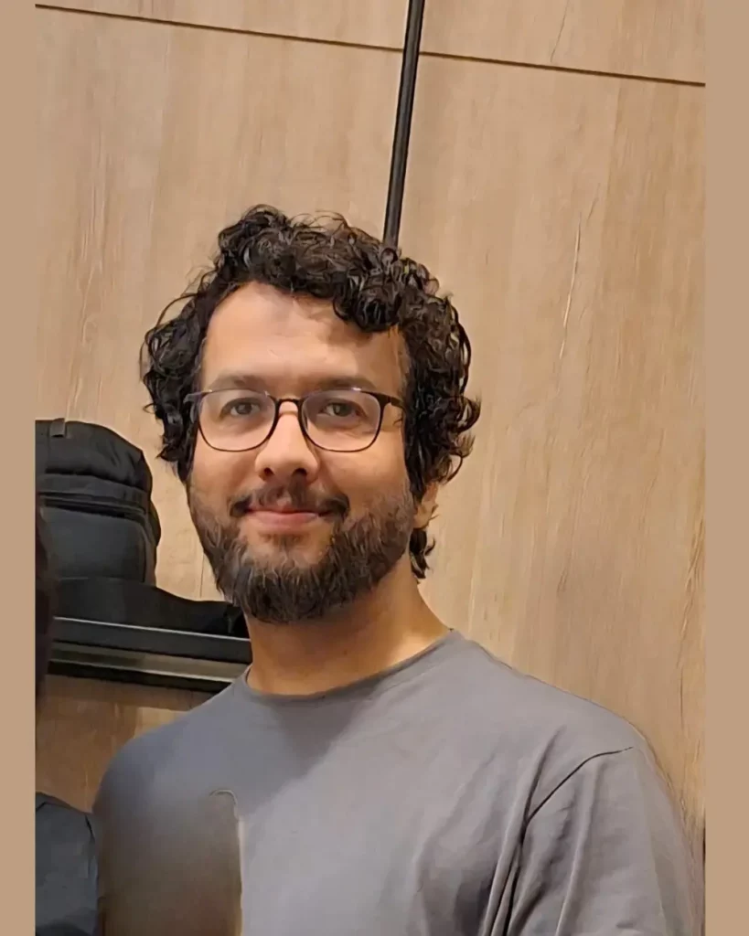 Sikander Jafar, WordPress Developer and SEO Strategist, smiling and wearing a grey T-shirt.